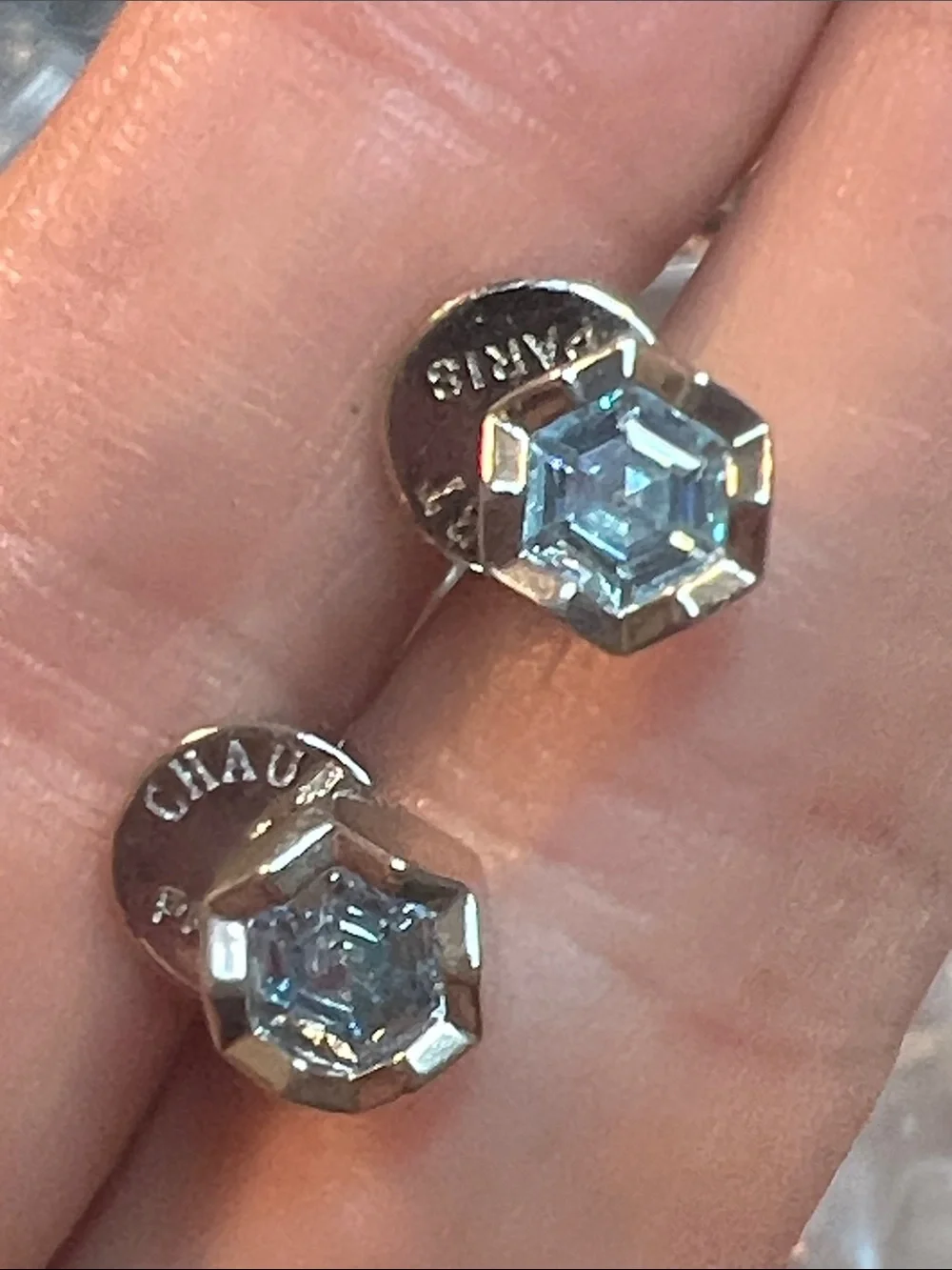 Round  Blue Zirconia In a Gold Setting With Logo